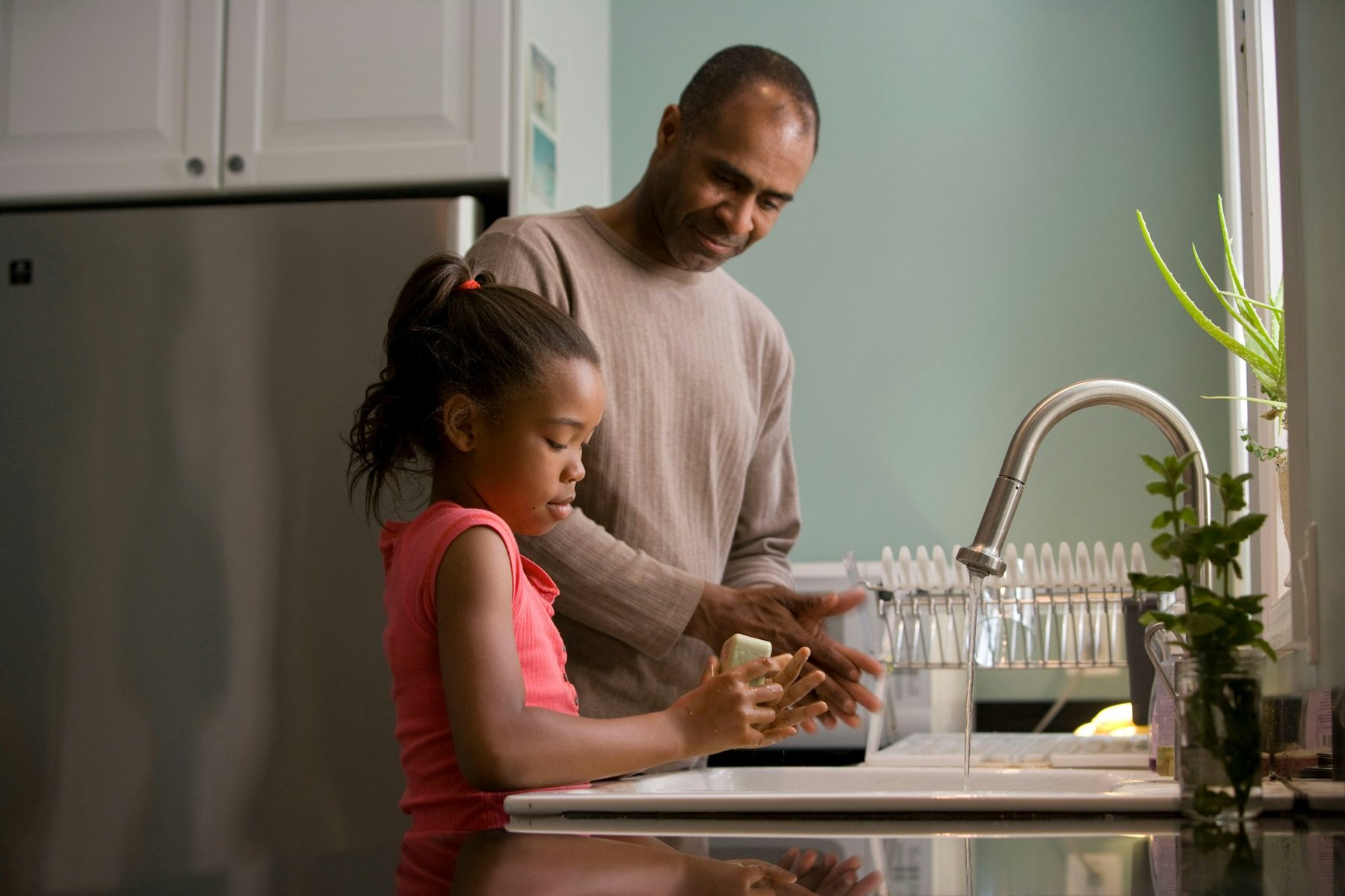 A girl washing her hands at a sink